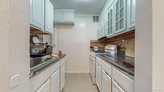 a kitchen with stainless steel appliances granite countertop a stove and a refrigerator