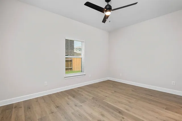 a view of a room with wooden floor and windows