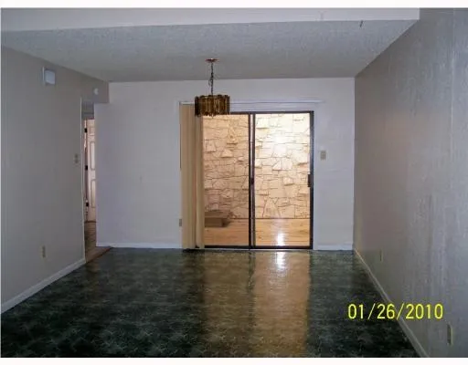 a view of wooden floor and window in a room
