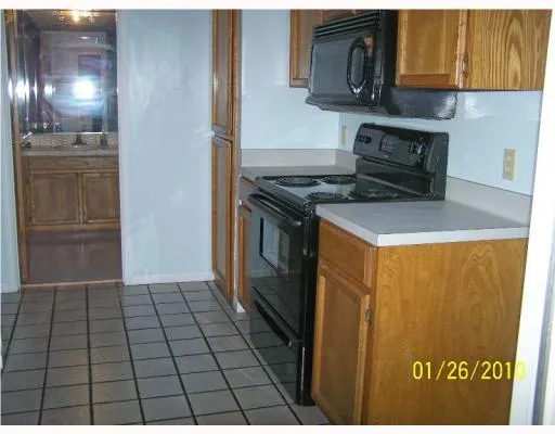 a kitchen with a stove top oven and cabinets