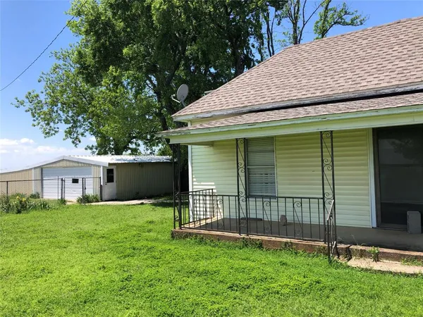 a front view of a house with a garden and yard