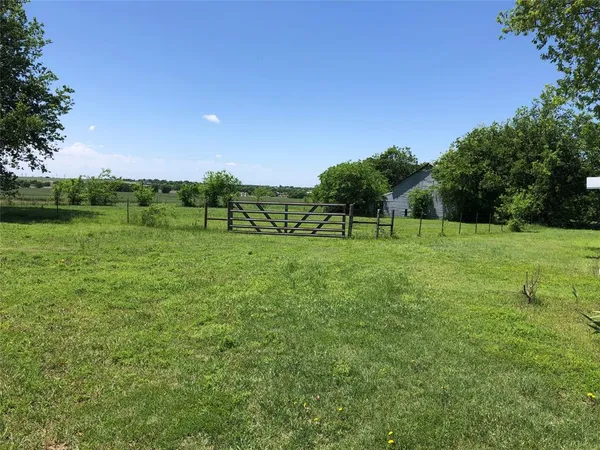 a view of a backyard of the house