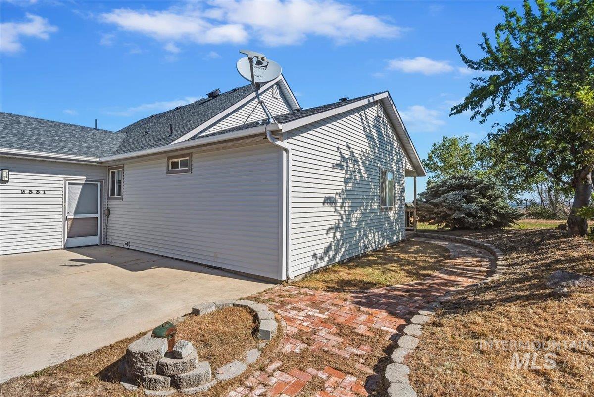 2331 Gulley Road Homedale, ID 83628 - Photo 34 of 46 Light-colored siding exterior featuring a dark asphalt shingle roof