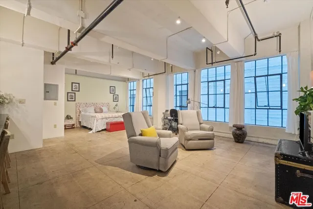 a living room with furniture ceiling fan and a rug