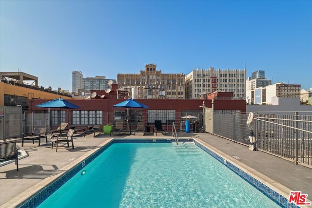 a view of a house with sitting area and swimming pool