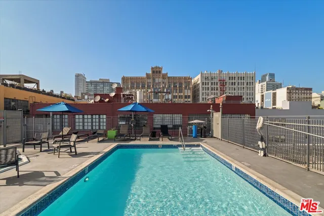a view of a house with sitting area and swimming pool