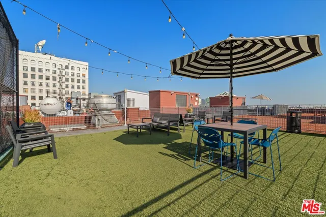 a view of a patio with couches table and chairs and potted plants
