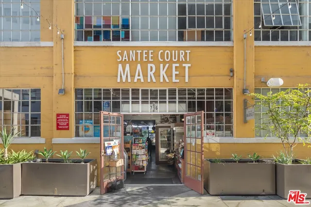 a picture of a bathroom with a white wall and a painting