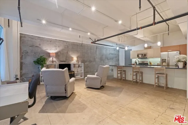 a living room with furniture and kitchen view