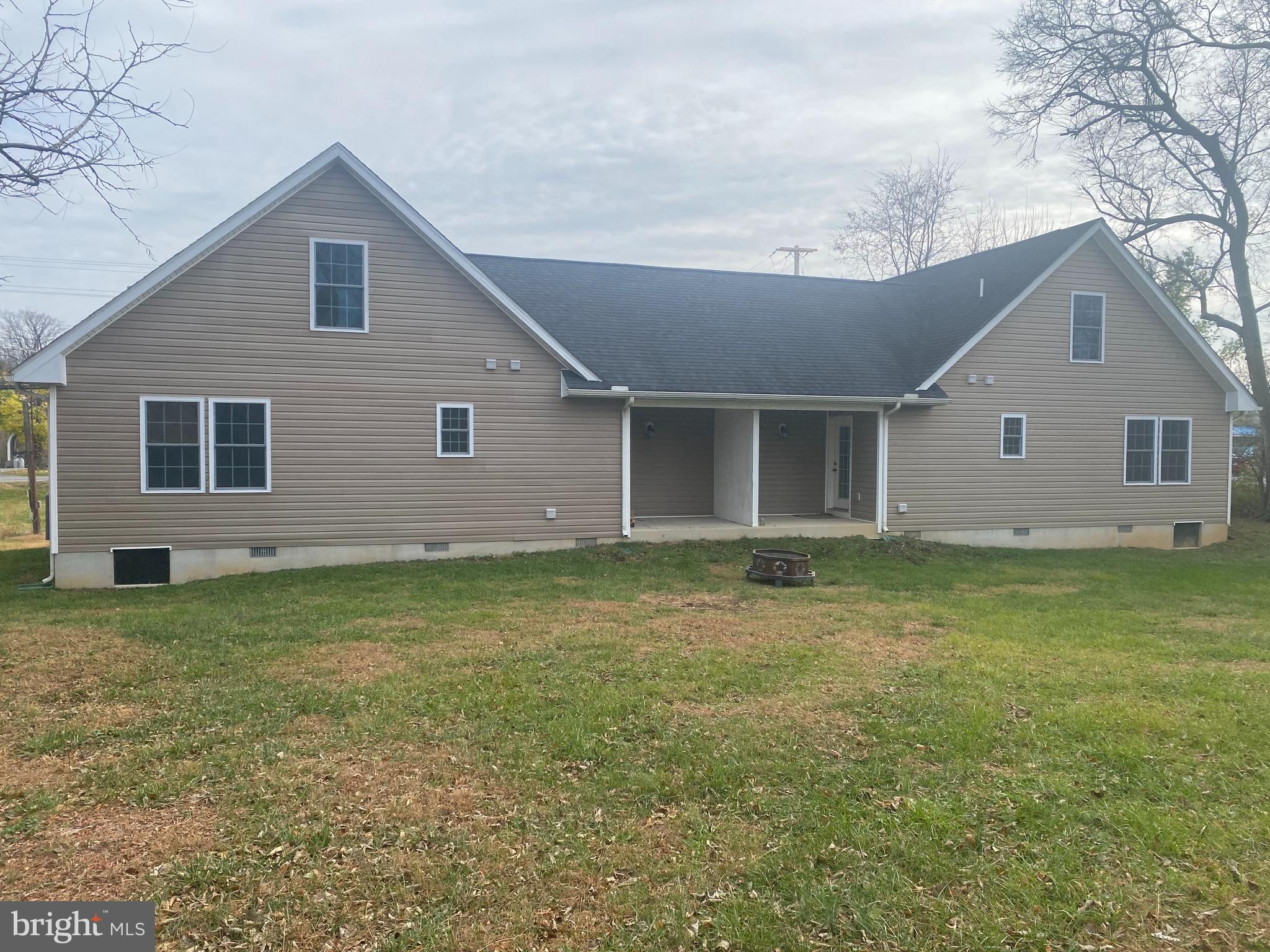 7052 Winchester Avenue Inwood, WV 25428 - Photo 16 of 17 a view of a house with a backyard