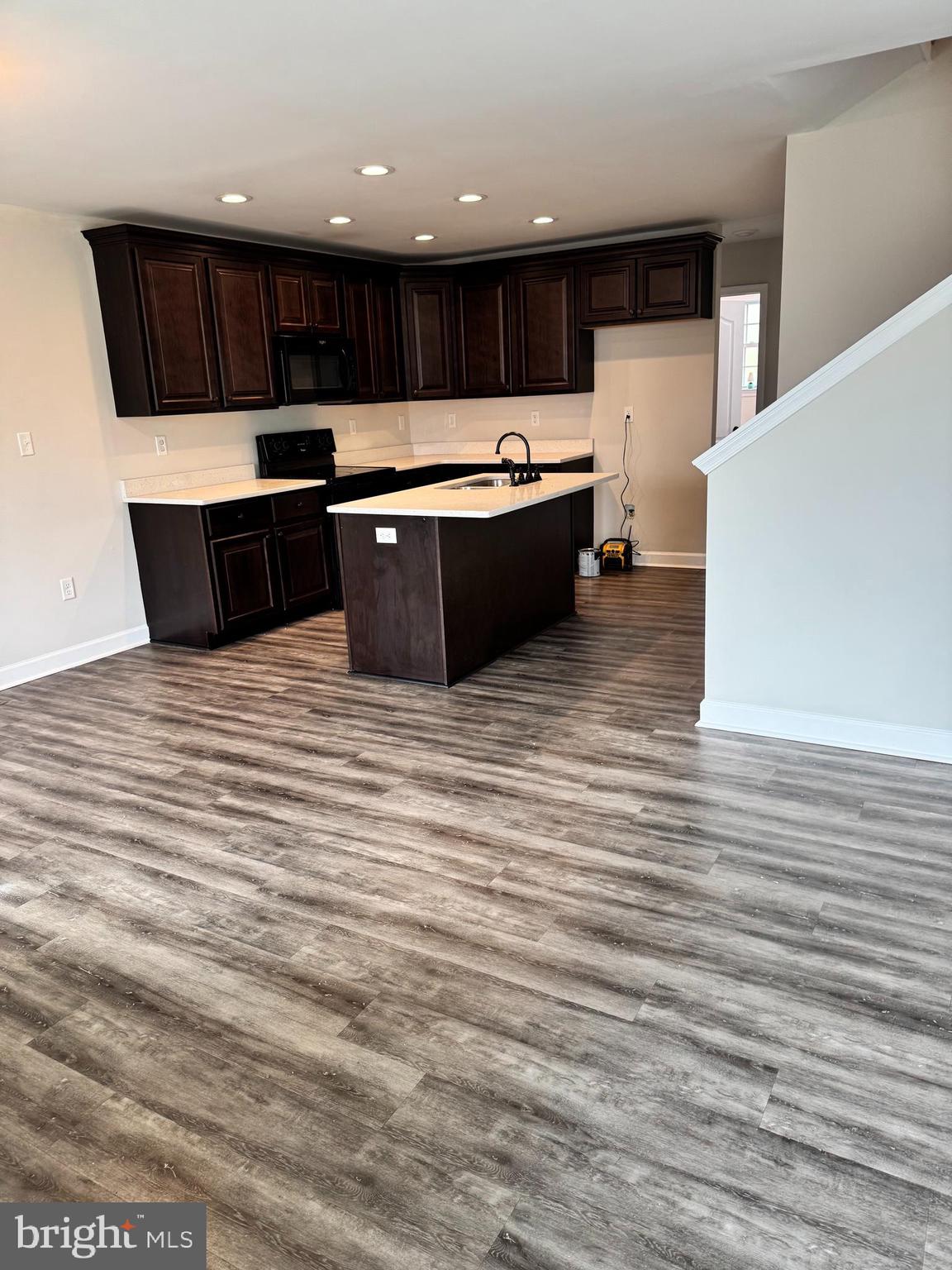 7052 Winchester Avenue Inwood, WV 25428 - Photo 5 of 17 a kitchen with stainless steel appliances kitchen island granite countertop a sink and a stove