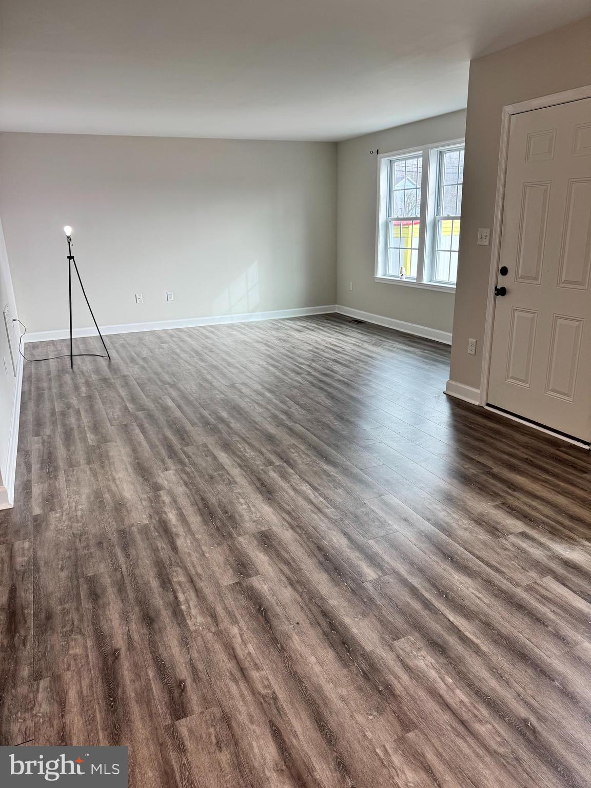 7052 Winchester Avenue Inwood, WV 25428 - Photo 6 of 17 wooden floor in an empty room with a window