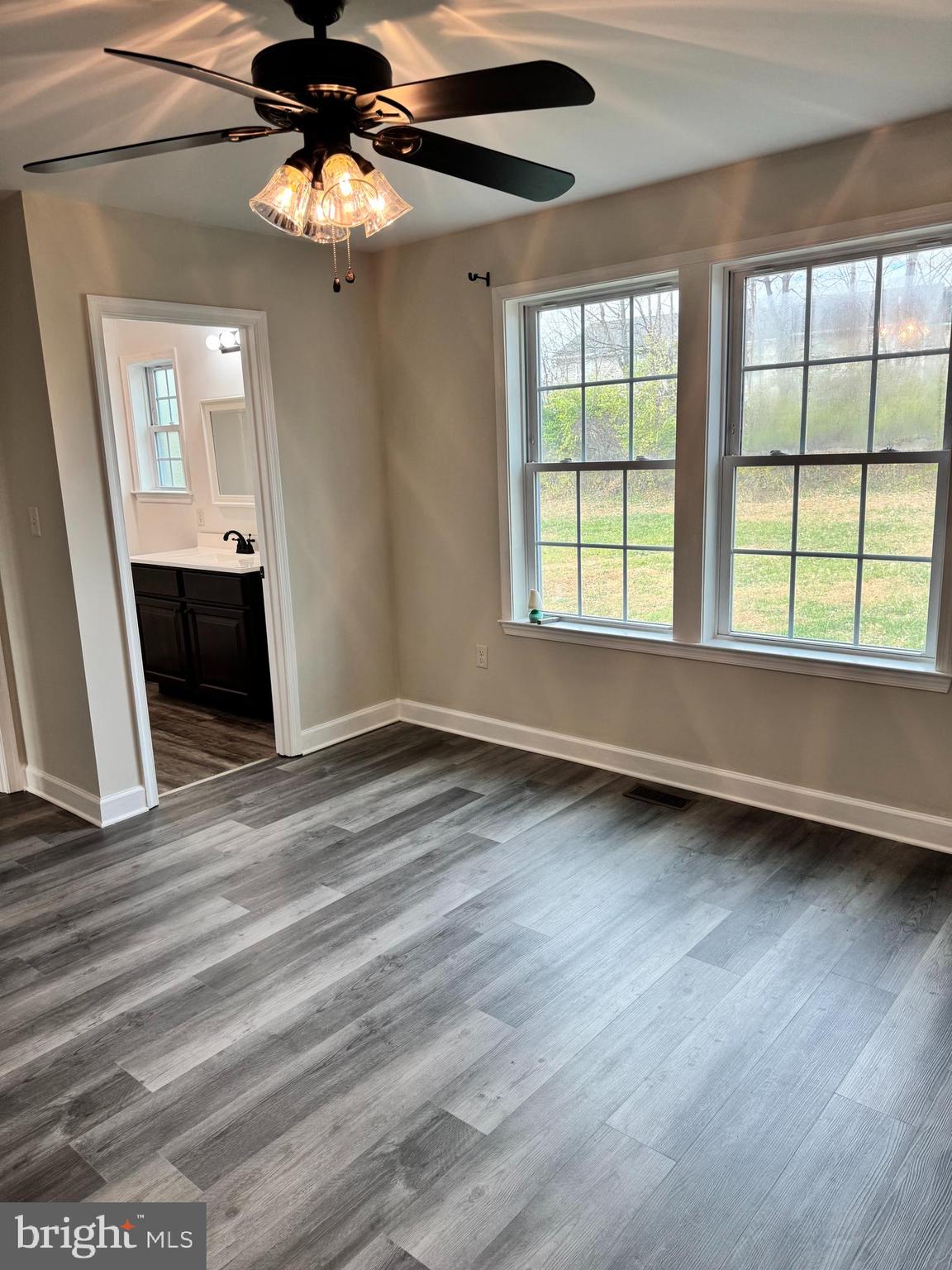 7052 Winchester Avenue Inwood, WV 25428 - Photo 6 of 17 a view of an empty room with a window and wooden floor