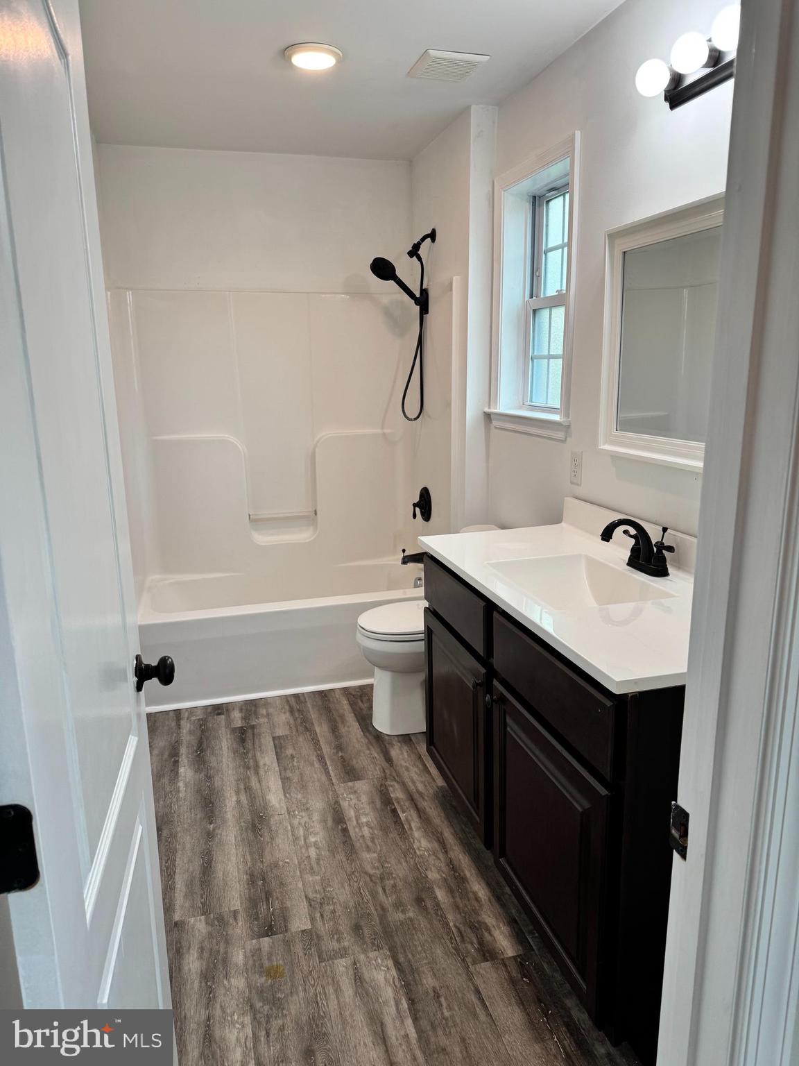 7052 Winchester Avenue Inwood, WV 25428 - Photo 8 of 17 a bathroom with a sink a toilet and shower