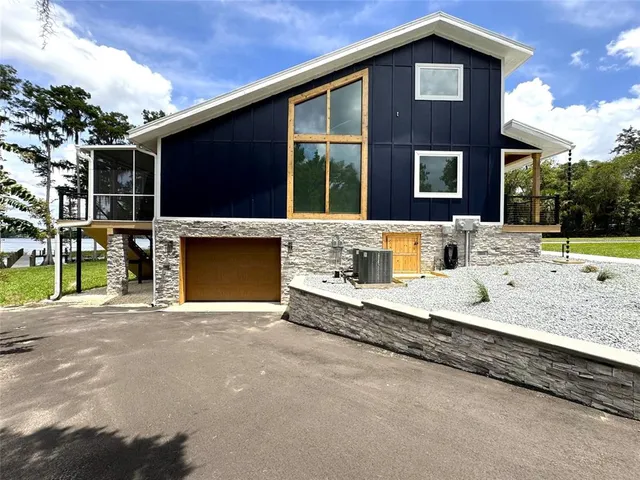 a view of a house with a swimming pool and sitting area