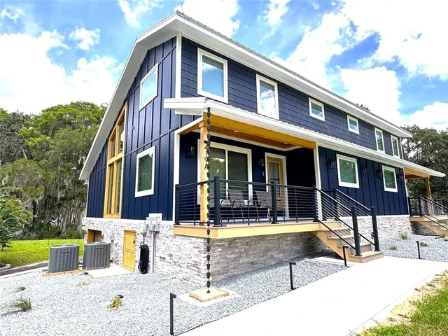 a kitchen with stainless steel appliances granite countertop a sink a stove a refrigerator and island