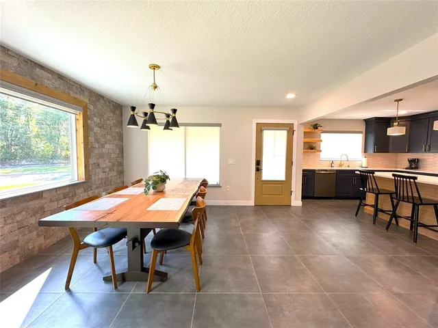 a view of a chairs and table in a backyard