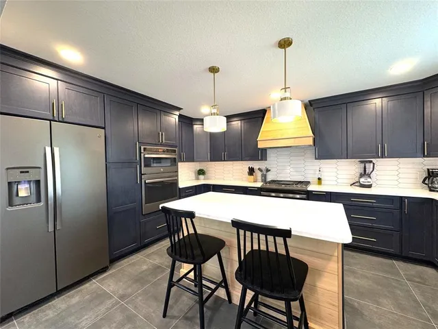 a view of a dining room and livingroom with furniture wooden floor a chandelier