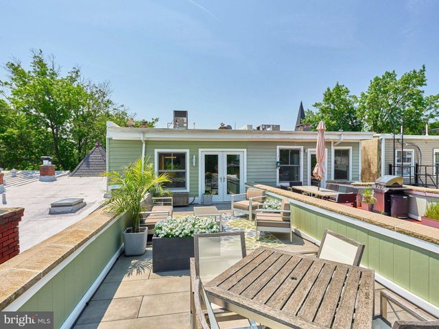 a view of a house with pool and chairs