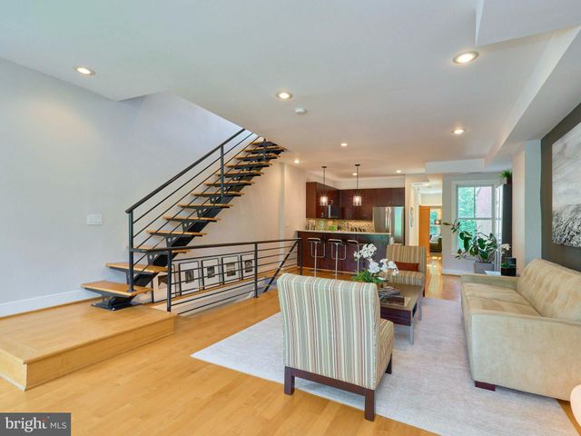 a living room with furniture and stairs