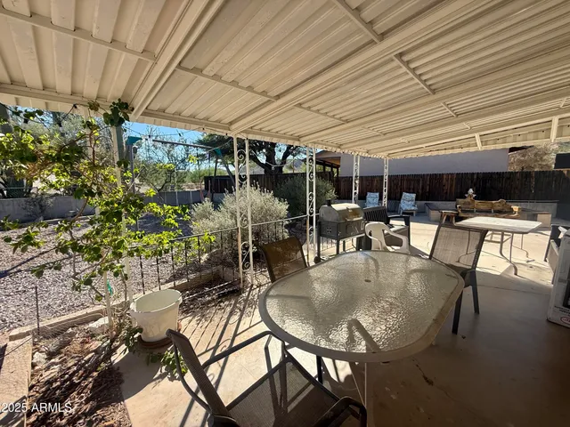 a view of a patio with table and chairs and potted plants