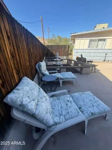 a living room with couches coffee table and chairs with wooden floor