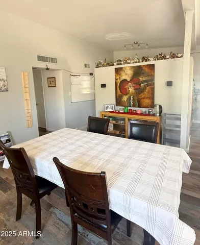 a kitchen with a wooden table and chairs