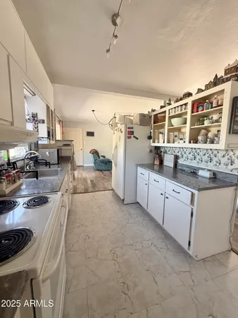 a kitchen with stainless steel appliances granite countertop a stove and cabinets
