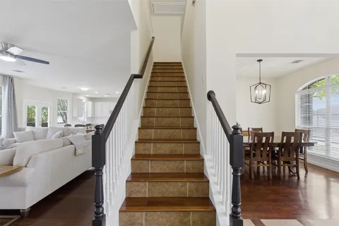 a view of staircase with dining table and wooden floor