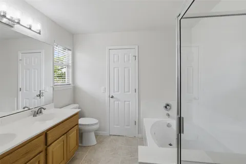 a bathroom with a granite countertop sink toilet a shower and a mirror