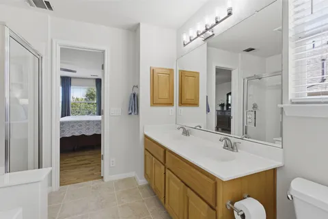 a bathroom with a sink a light fixture and a mirror