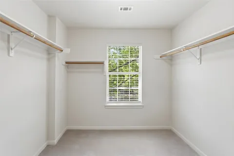 a view of room with window and a ceiling fan