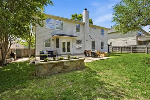 a view of a house with swimming pool and sitting area