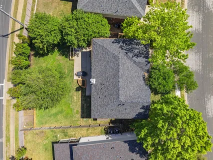 an aerial view of a house with a yard