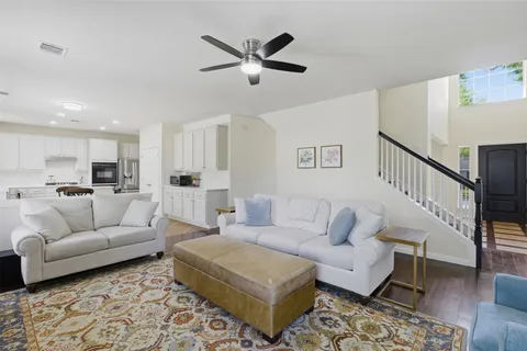 a living room with furniture and kitchen view