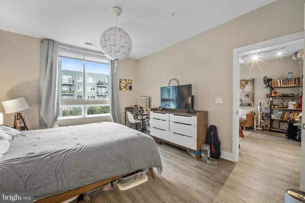 a bedroom with a bed and a chandelier