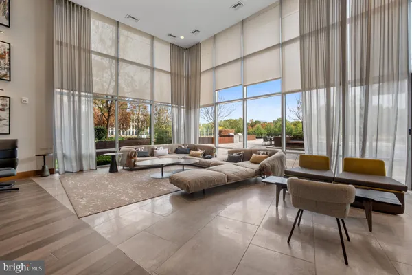 a living room with furniture and large windows