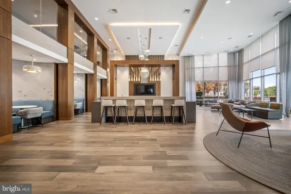 a room with lots of furniture and wooden floors