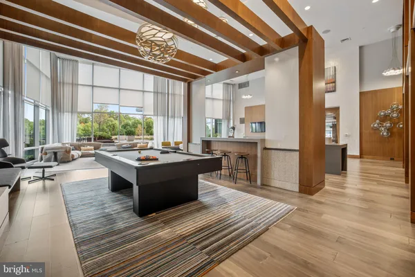 a living room with lots of furniture and a large window