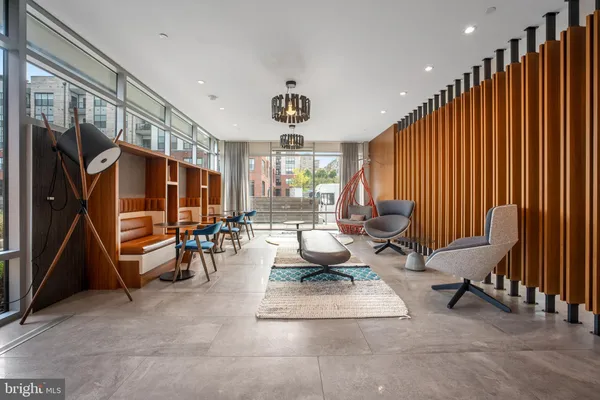 a room with lots of wooden furniture and glass door