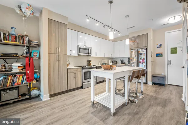 a kitchen with stainless steel appliances granite countertop a sink a stove top oven a counter space and cabinets