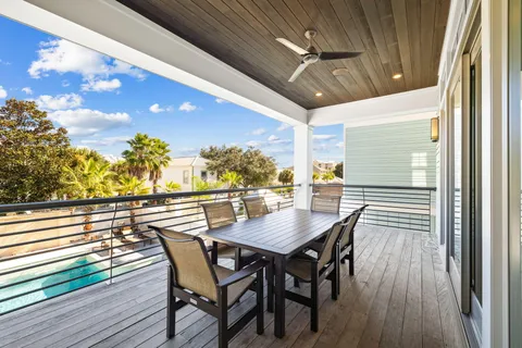a bedroom with a bed a mirror on dresser and a window