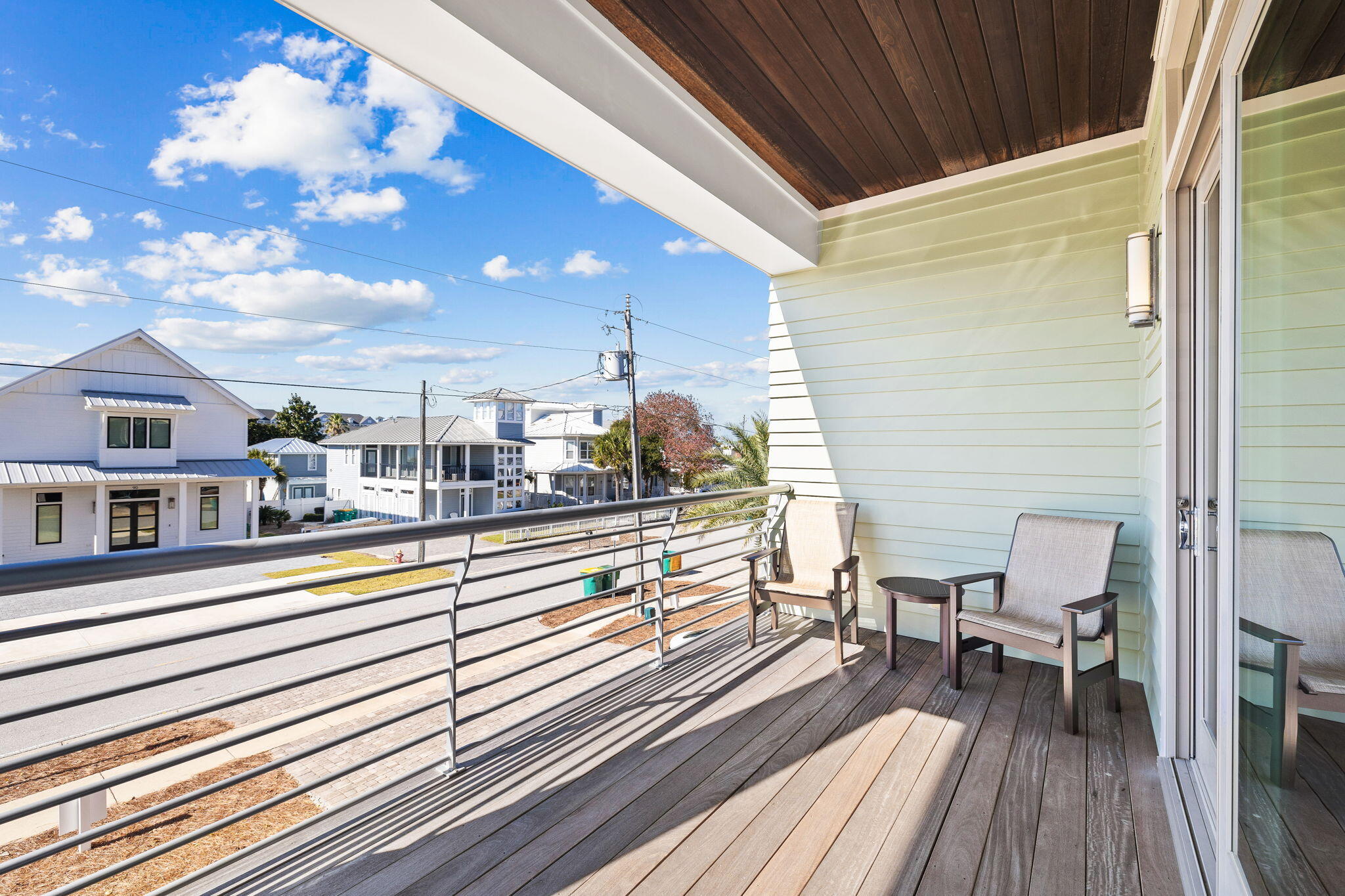 89 Shirah Street Destin, FL 32541 - Photo 30 of 69 a view of a balcony with chairs and wooden floor