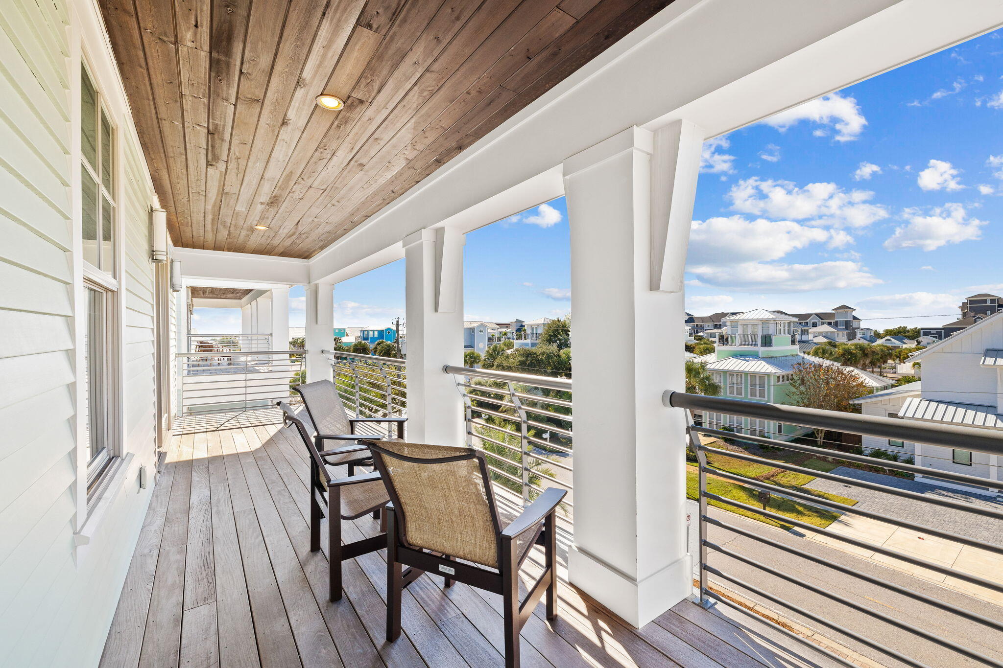 89 Shirah Street Destin, FL 32541 - Photo 53 of 69 a view of a balcony with chairs and wooden floor