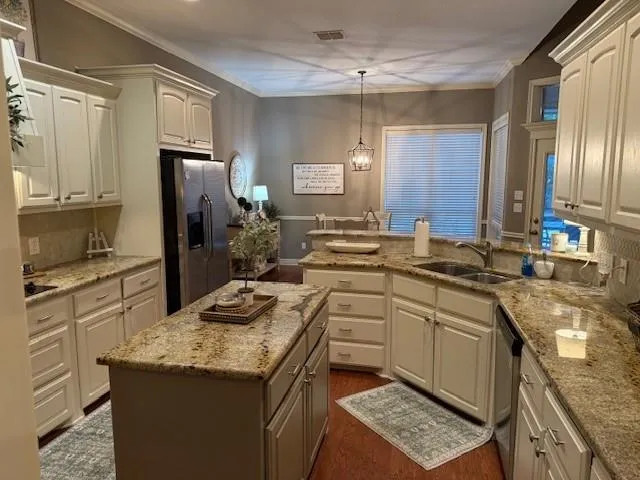 a kitchen with a sink stove and refrigerator