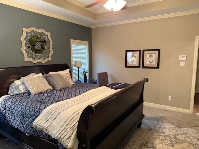 a bedroom with bed and painting on the wall