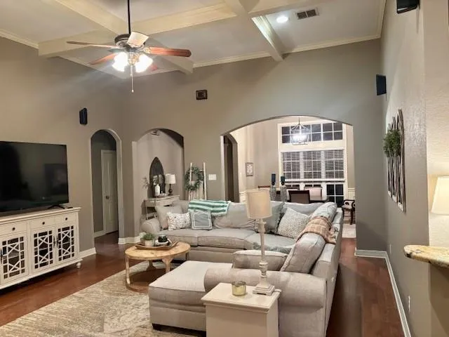 a living room with furniture a flat screen tv and a window