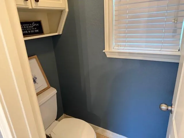 a white toilet sitting next to a sink