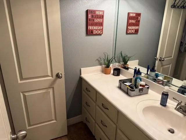 a bathroom with a sink toilet and mirror