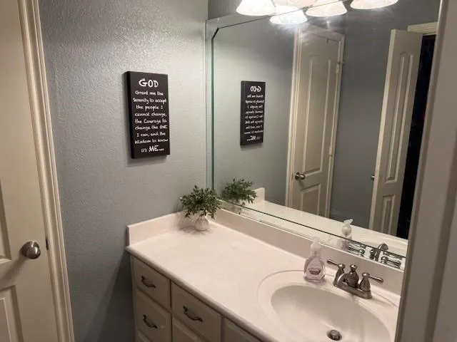 a bedroom with a large bed and wooden floor